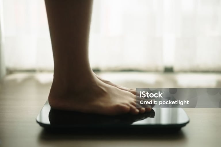 a person standing on a scale with their feet on a scale