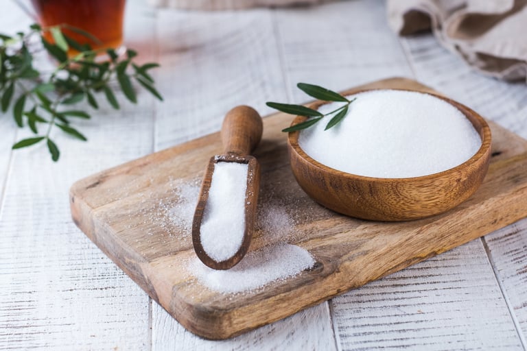 a wooden bowl with stevia and a wooden spoon
