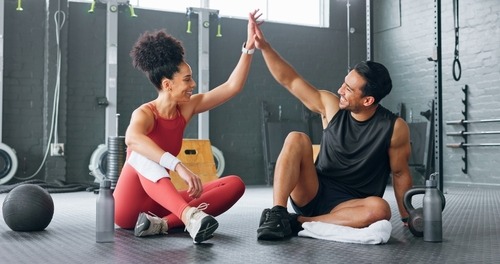 a man and woman giving high five fingers 