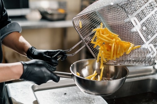 a man cooking french fries