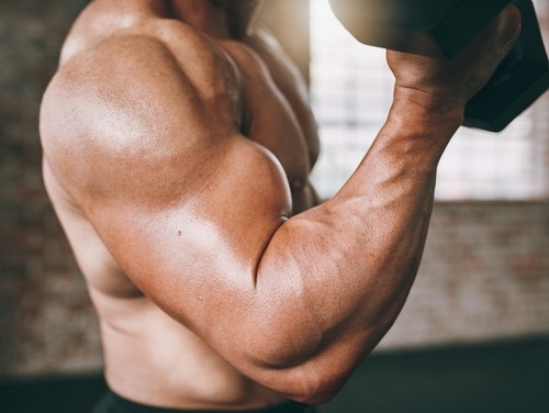 a man with a dumbbell in his hand