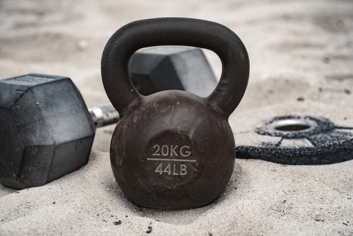 a kettlebell and a pair of dumbells