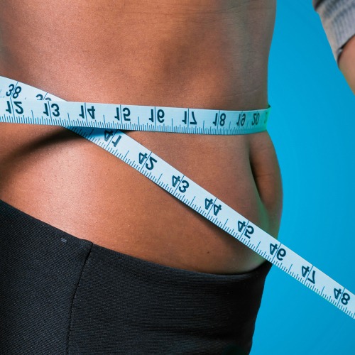 a woman's waist with a measuring tape measure tape around her waist