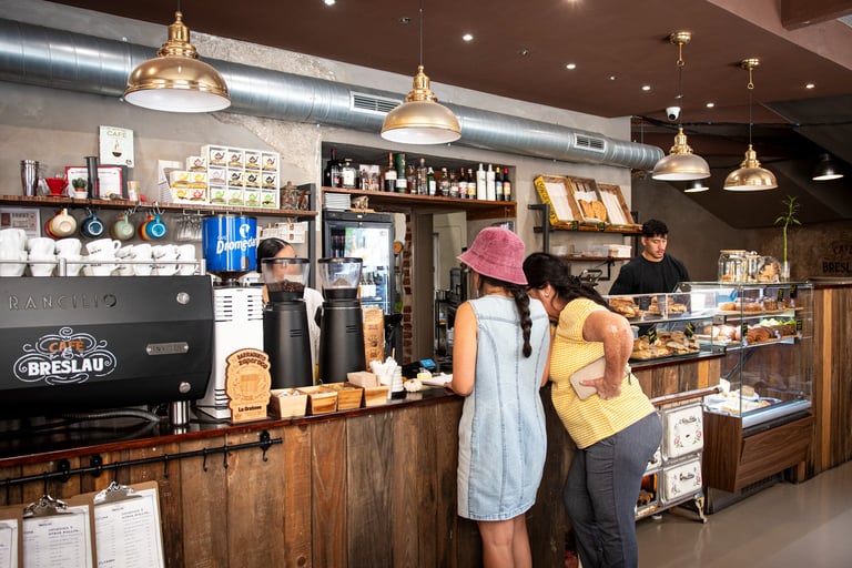 Customers being served at Cafe Breslau, a partner of Bencomo Coliving.