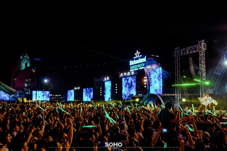 a crowd of people standing in front of a stage
