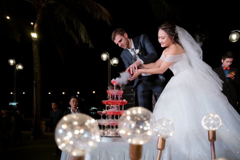 a bride and groom cutting their wedding cake
