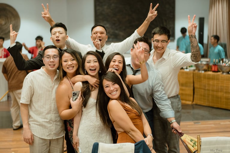 a group of people standing around a table
