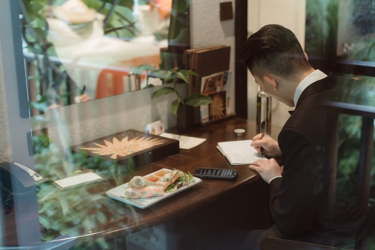 a man in a suit and tie is sitting at a table