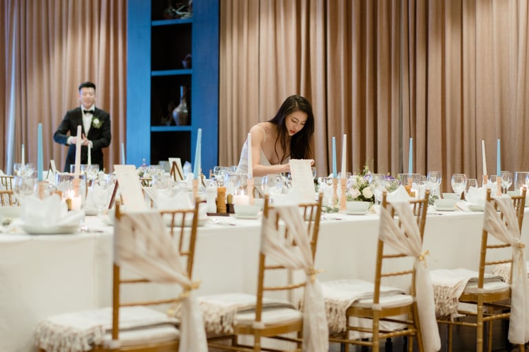 a woman is sitting at a table with candles and candles