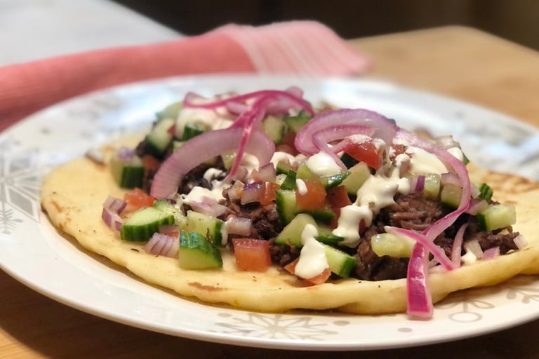 chuck roast gyro with garlic sauce and pickled onions