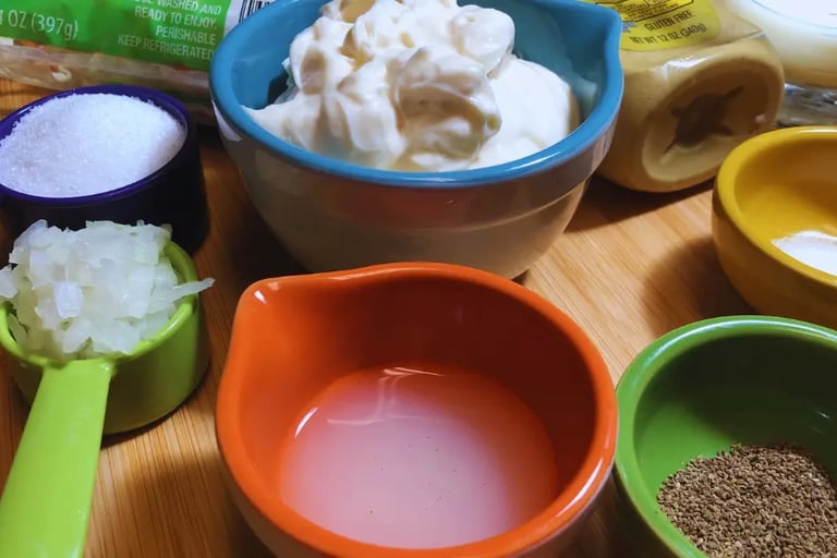 Prepared coleslaw ingredients in individual bowls, ready for mixing