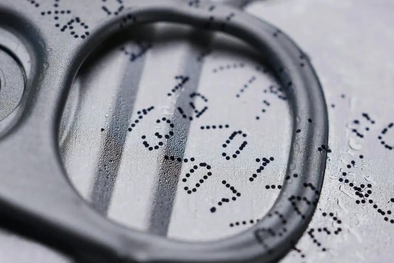 Close-up of expiration date printed on canned food top