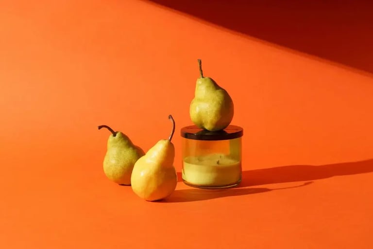 pears and candle with an fall colored orange background