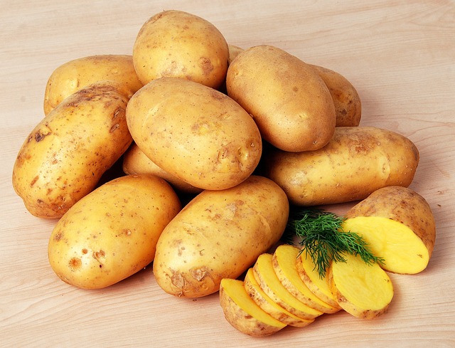 sliced potatoes with whole yellow potatoes