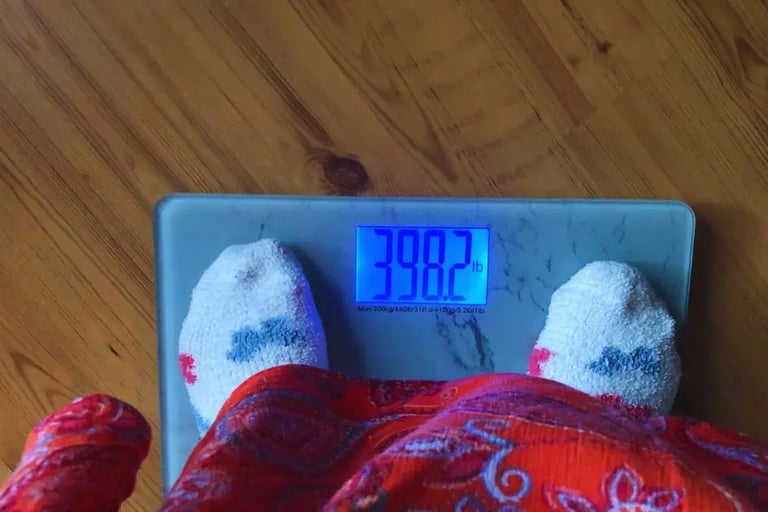 feet on marble looking weight loss scale showing weight