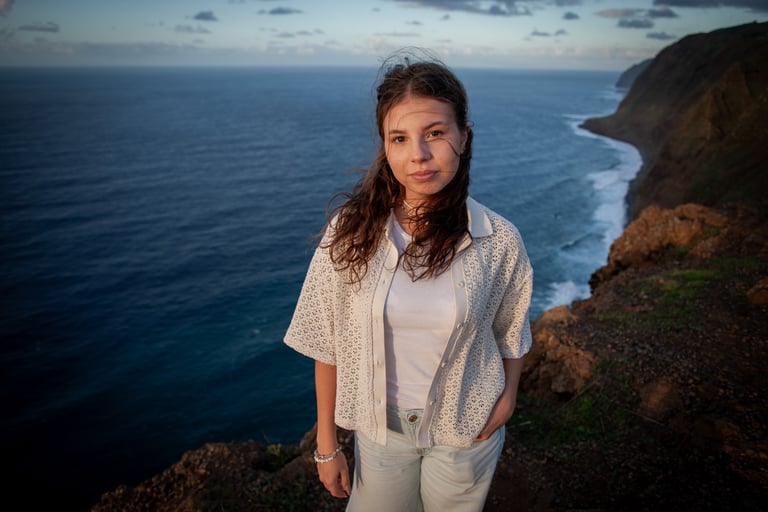 Young woman portrait at Ponta do Pargo cliff edge at dusk