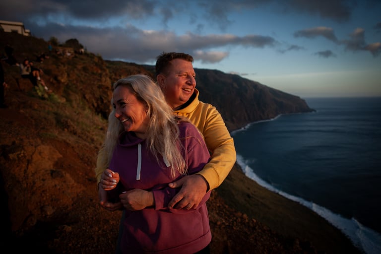 Couple embracing, smiling at Ponta do Pargo during twilight sunset