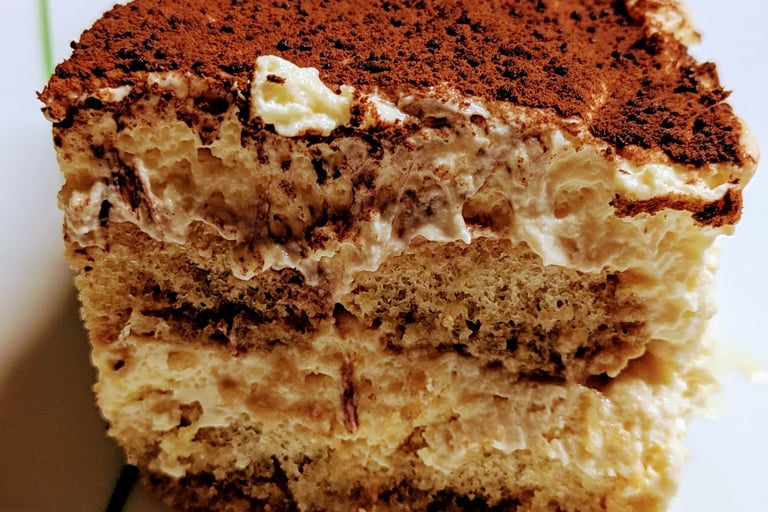 A rich, delicious slice of Tiramisu with Chocolate covered top