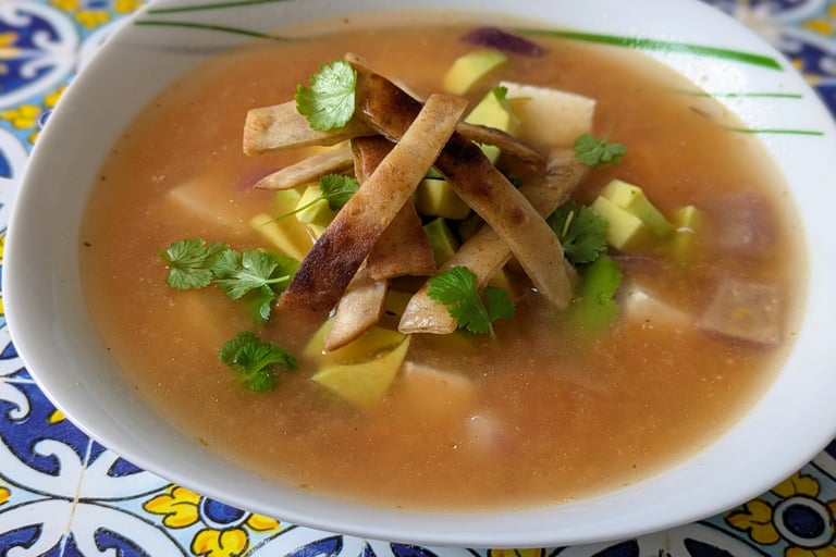 A fragrant bowl of Mexican Lime soup - Sopa De Lima with an Indian twist of Paneer for Protein, garnished with fried Tortilla