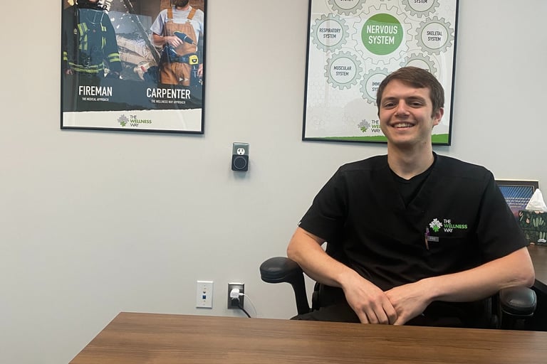 Dr. Sean smiling in his office with his patient 