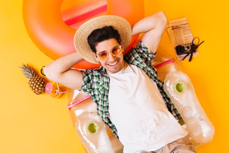 a man in a hat and sunglasses laying on a float ring