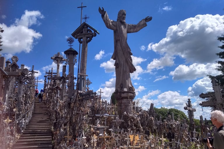 A wooden statue of Jesus stands amidst thousands of wooden crosses at the Hill of Crosses in Lithuania.
