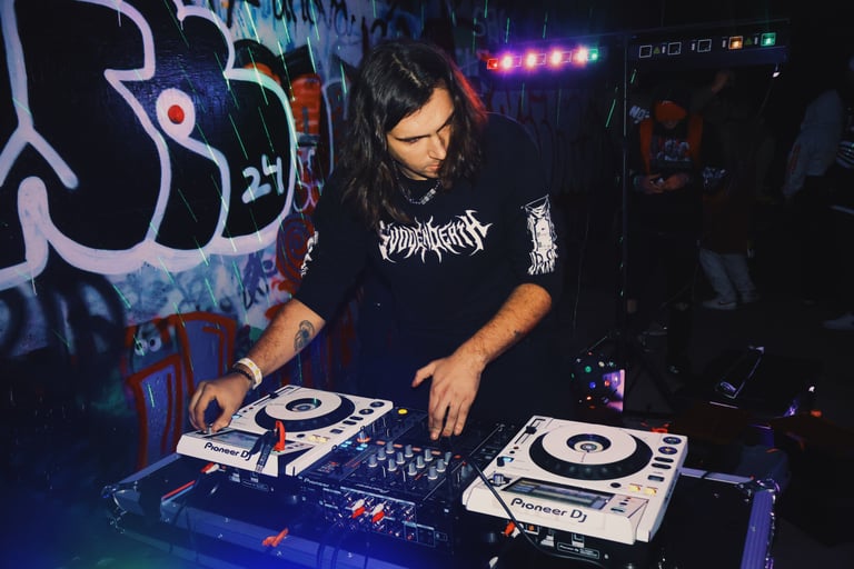 a man in a black shirt is playing a dj - Creechur