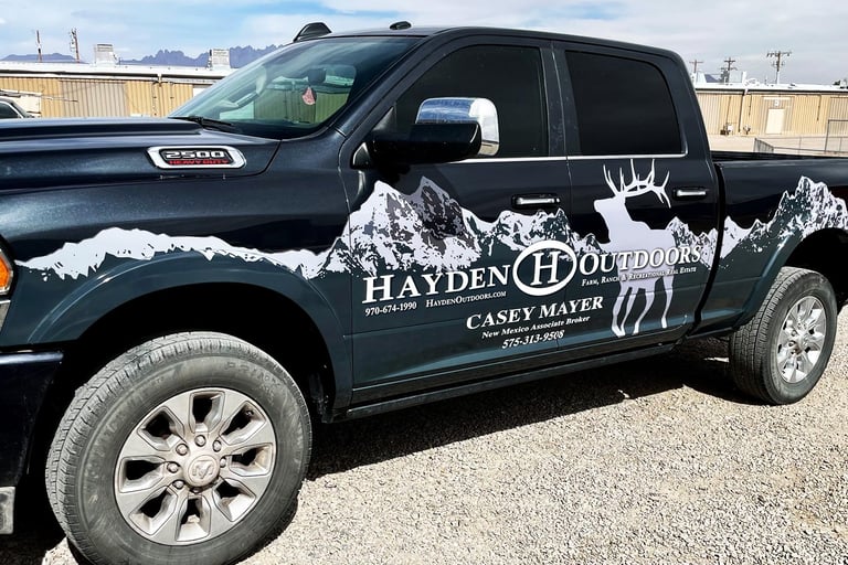 Partial truck wrap with a custom design of mountains for a local broker in Las Cruces, NM 