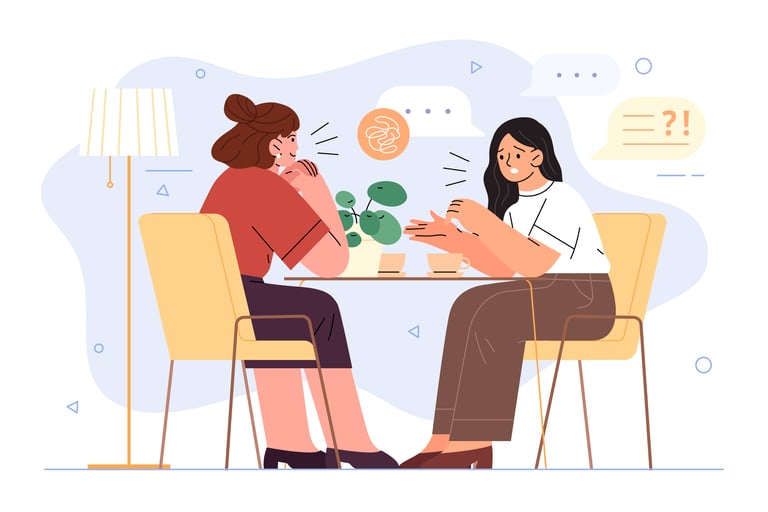 Dos mujeres sentadas a una mesa y se miran y se hablan