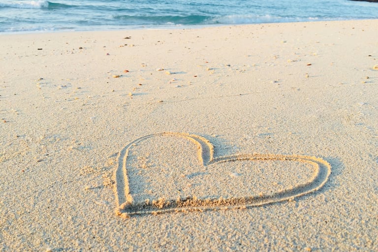 a heart shaped heart drawn in the sand