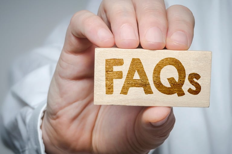 a person holding a wooden block with the word faqs on it
