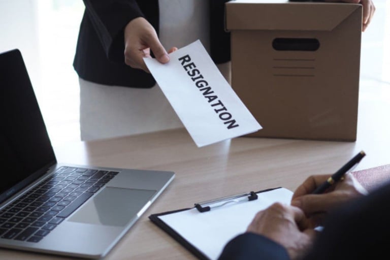 a person holding a piece of paper with a paper sign that says, 'resignation"