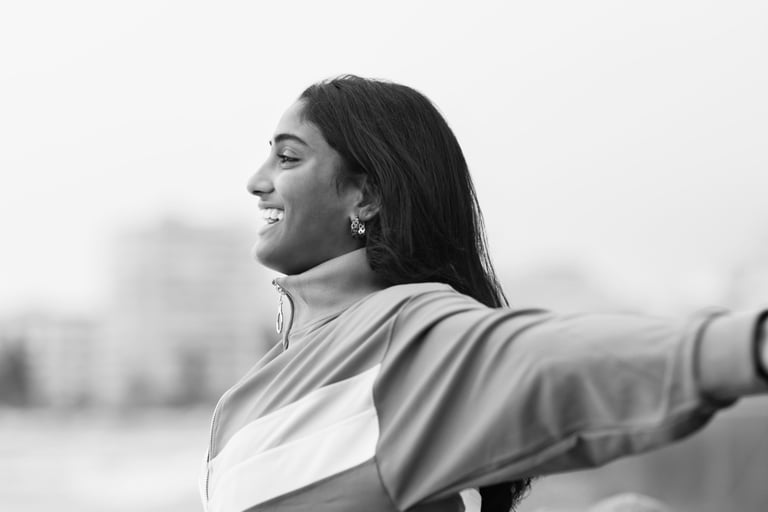 a woman with her arms outstretched out and smiling