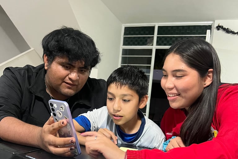 Three students learning English on their cellphones using digital Apps.