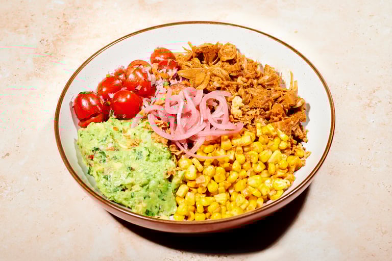a bowl of food with a variety of vegetables