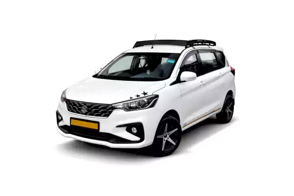 White Maruti Ertiga one way taxi by Saini taxi services with a luggage carrier rack