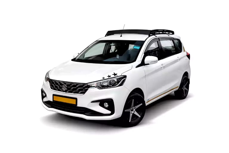 White Maruti Ertiga one way taxi by Saini taxi services with a luggage carrier rack