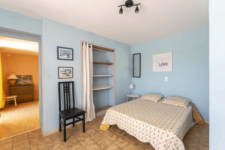 a bedroom with a bed and a chair