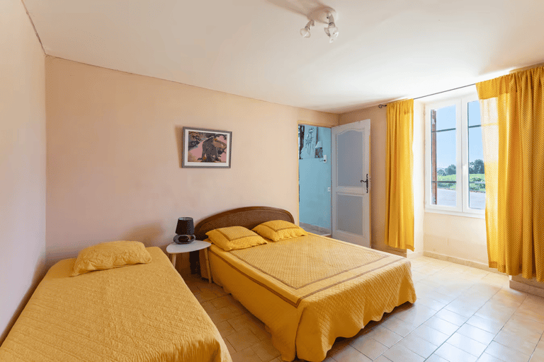 a bedroom with two beds and a table
