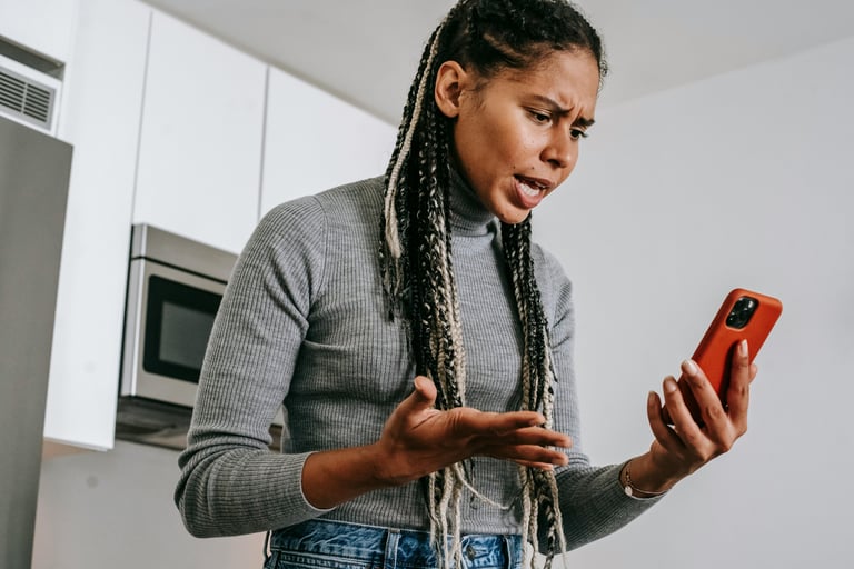 a woman with dreadlocks and a cell phone