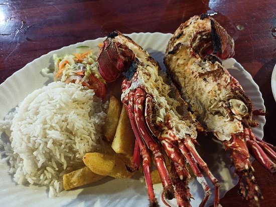Grilled lobster on a rice and french fries bed