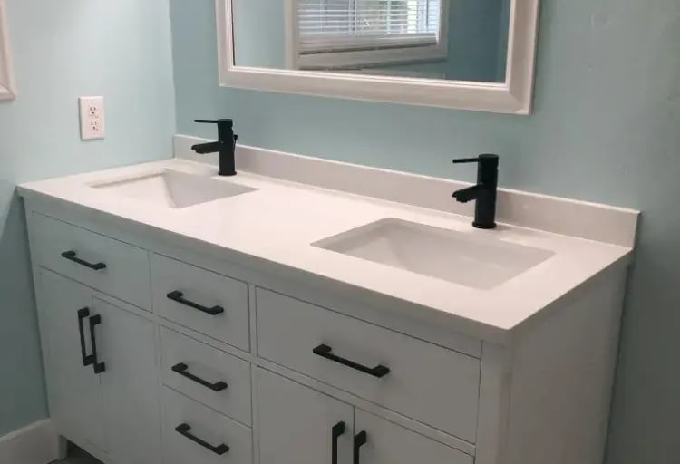 Renovated bathroom with double vanity and modern fixtures at Malad House. Premium Boise State student housing in Boise.