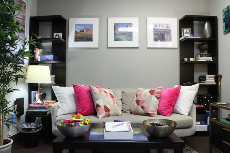 a therapy room with a couch and a coffee table