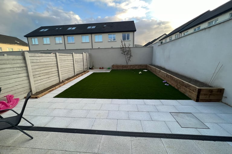 a backyard patio with a lawn and a lawn chair