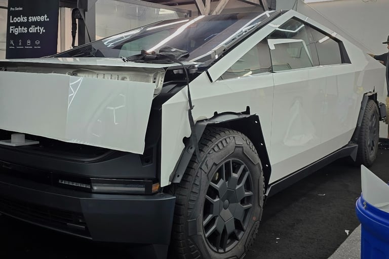 White matte Paint Protection Film (PPF) installation in progress on a Tesla Cybertruck in Livermore,