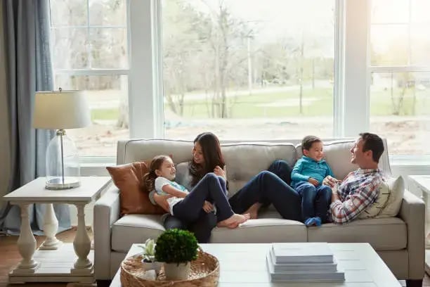 Family is relaxing comfortably because their electric and HVAC systems are safe, and keeping them comfortable.