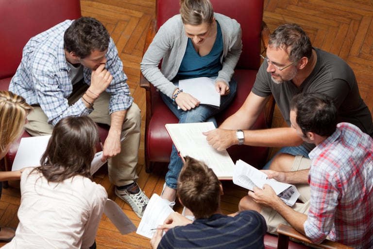 a group of people sitting around a table
