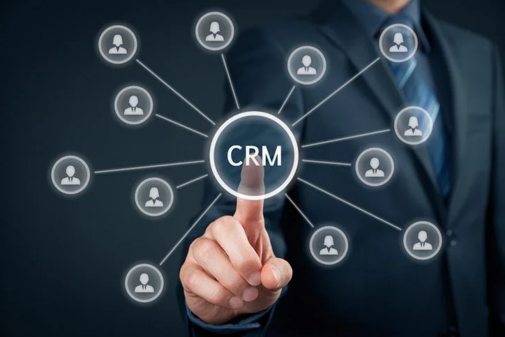 a person pointing at a crm button