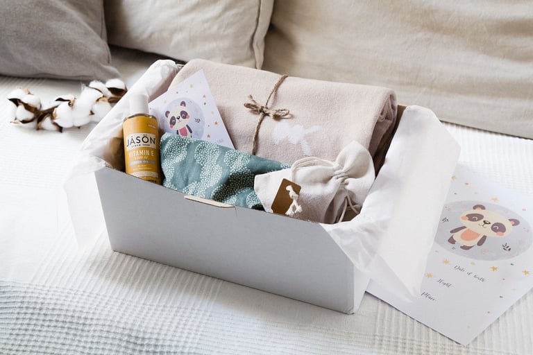 A box with pillow, oil, bib, blanket and wall pockets.
