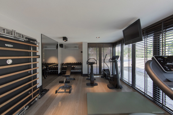 a gym room with a treadmill and a treadmill